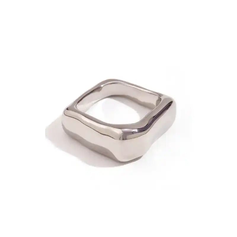 Silver ring with a geometric design on a white background
