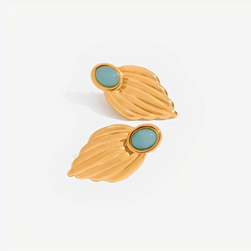 Gold leaf-shaped earrings with turquoise stones on a white background