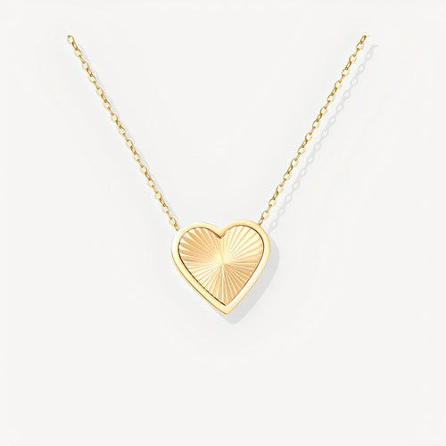 Gold heart-shaped pendant necklace on a white background