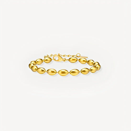 Gold bracelet on a light gray background