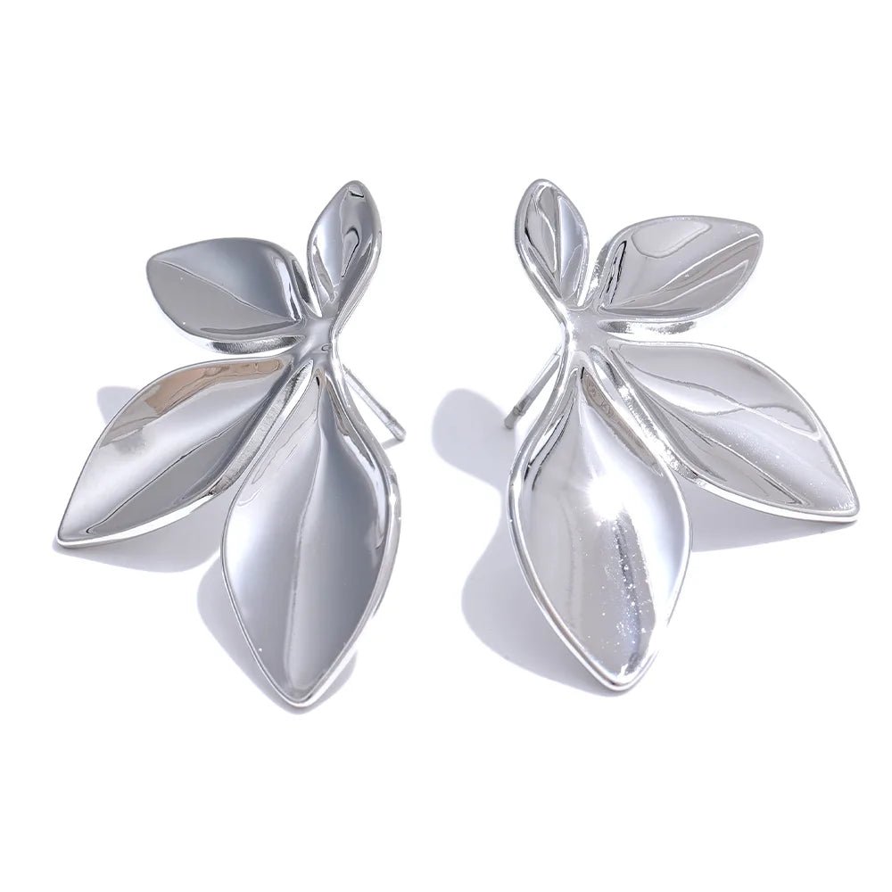 Pair of silver leaf-shaped earrings on a white background