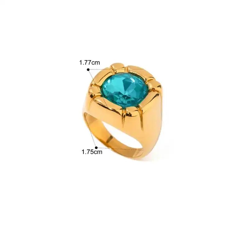 Gold ring with a blue gemstone on a white background