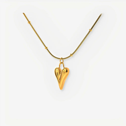Gold heart-shaped pendant necklace on a white background