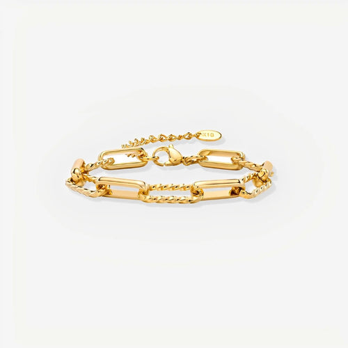 Gold chain bracelet on a light gray background