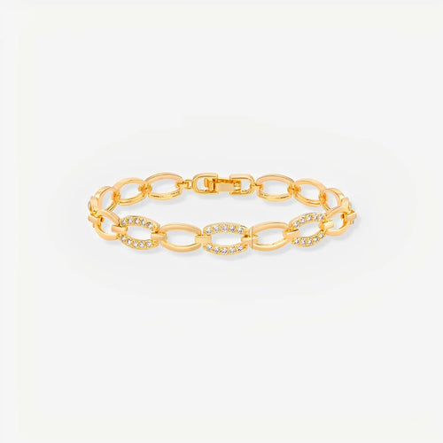 Gold chain bracelet on a light gray background