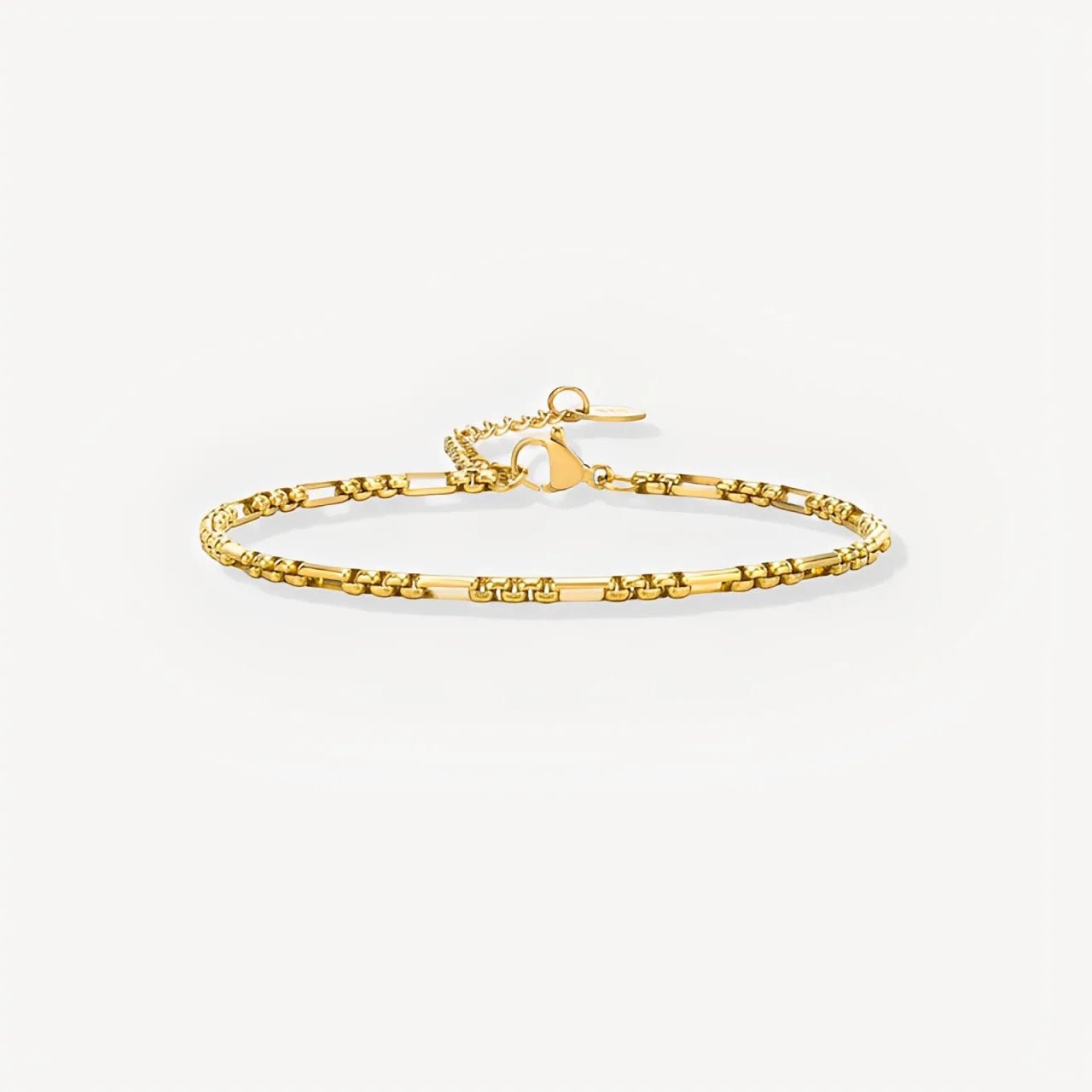 Gold bracelet on a light beige background