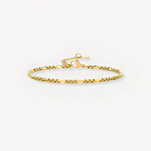 Gold bracelet on a light beige background