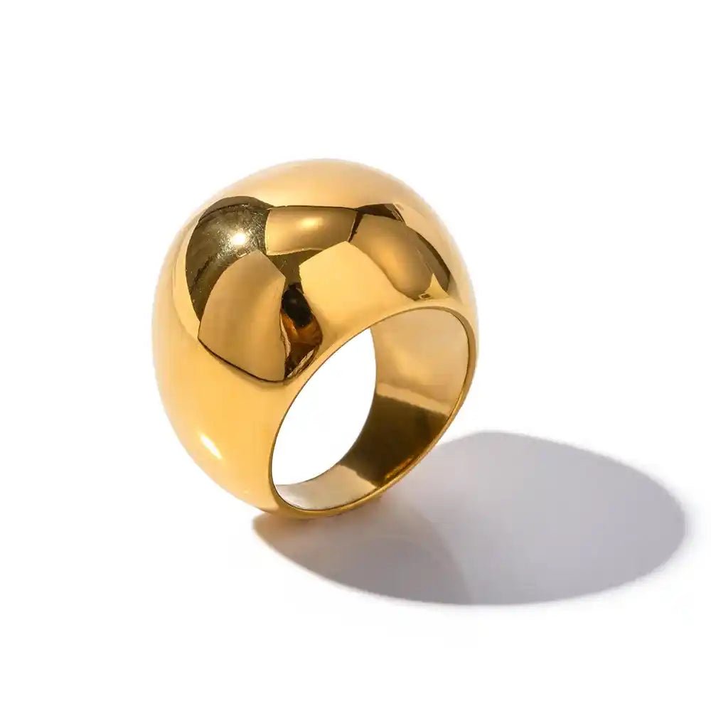 Gold ring with a textured surface on a white background