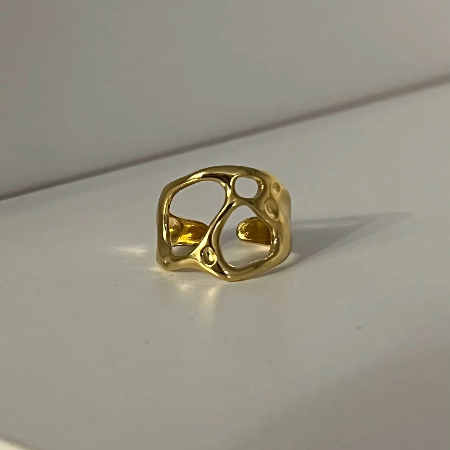 Gold ring on a light gray background