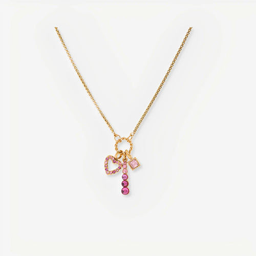Gold necklace with pink and red charm on a white background