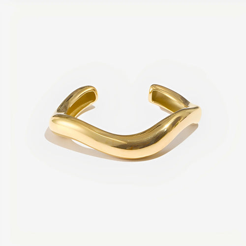 Gold bracelet on a light gray background