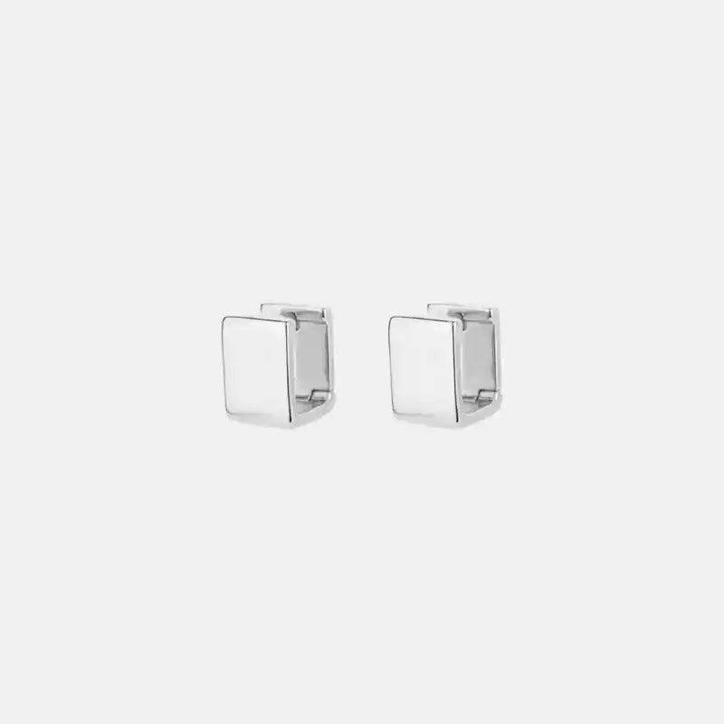 Pair of silver square earrings on a white background