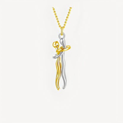 Two-tone gold and silver pendant on a white background