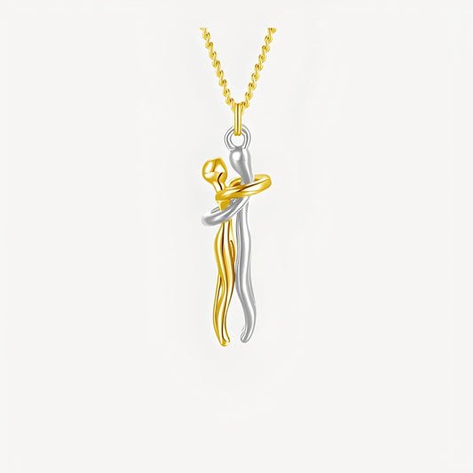 Two-tone gold and silver pendant on a white background