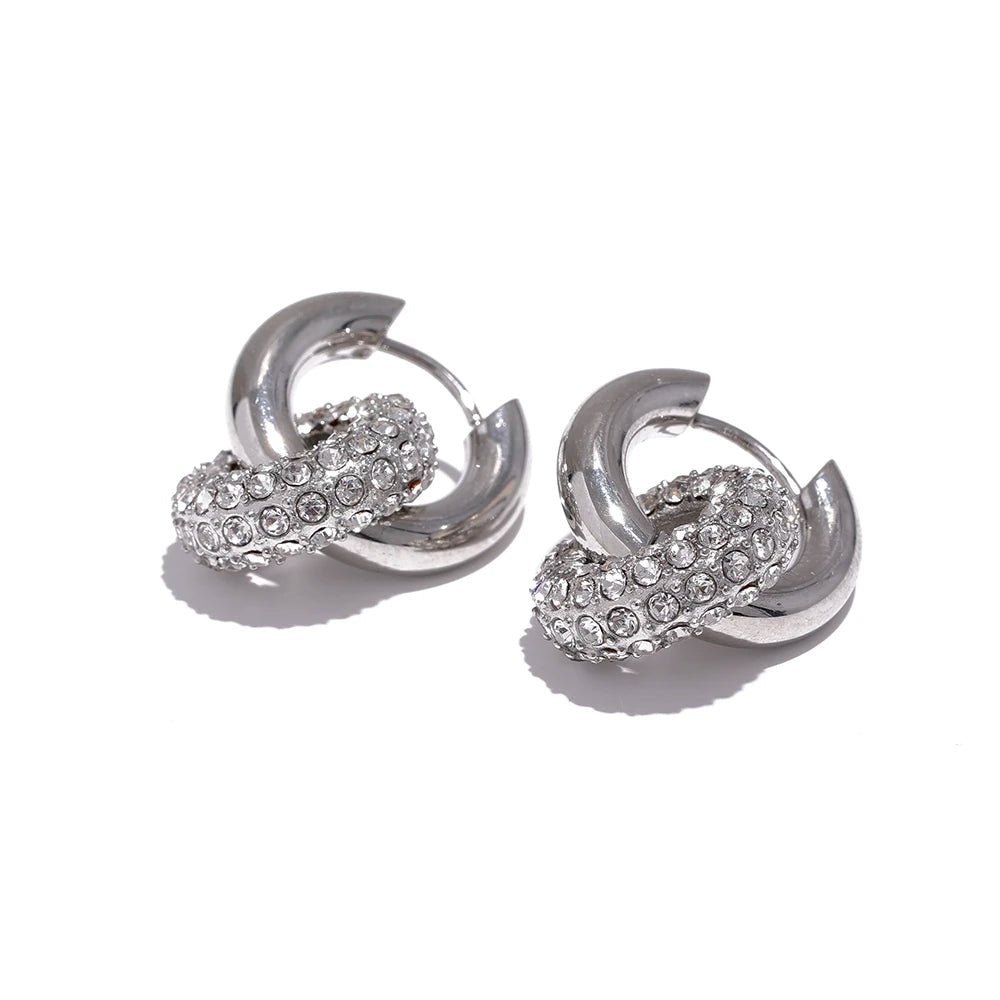 Pair of silver hoop earrings with embedded stones on a white background