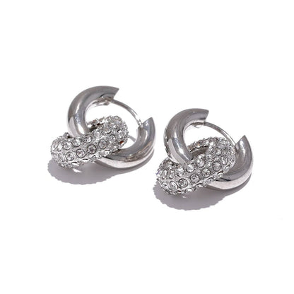 Pair of silver hoop earrings with embedded stones on a white background