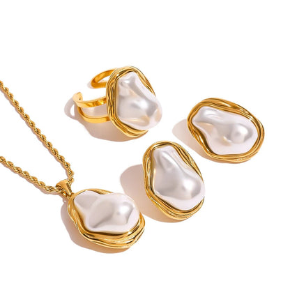 Jewelry set with gold and pearl accents on a white background