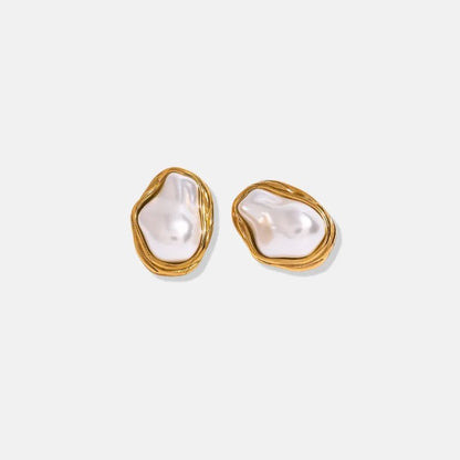 Pair of pearl earrings with gold frames on a white background