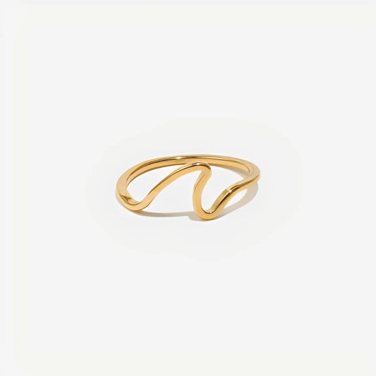 Gold ring with a wavy design on a white background