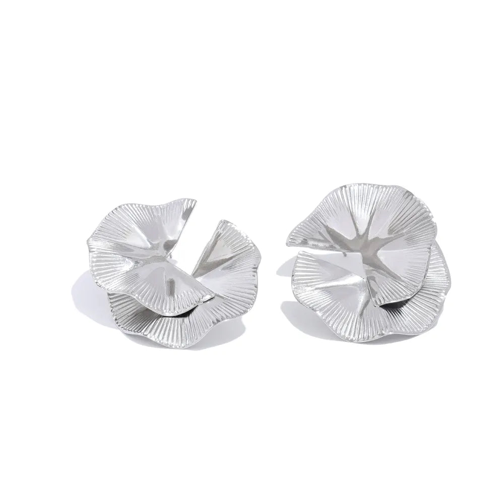 Pair of silver floral earrings on a white background