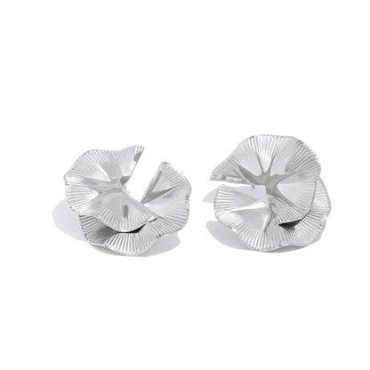 Pair of silver floral earrings on a white background