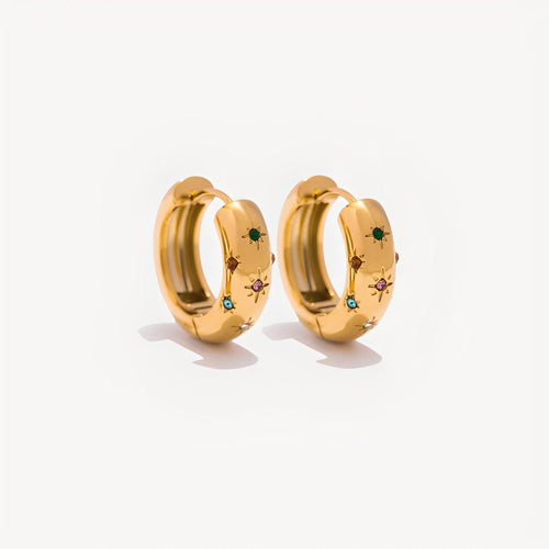 Gold hoop earrings with embedded gemstones on a white background
