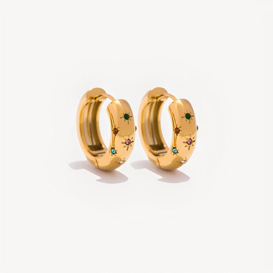 Gold hoop earrings with embedded gemstones on a white background