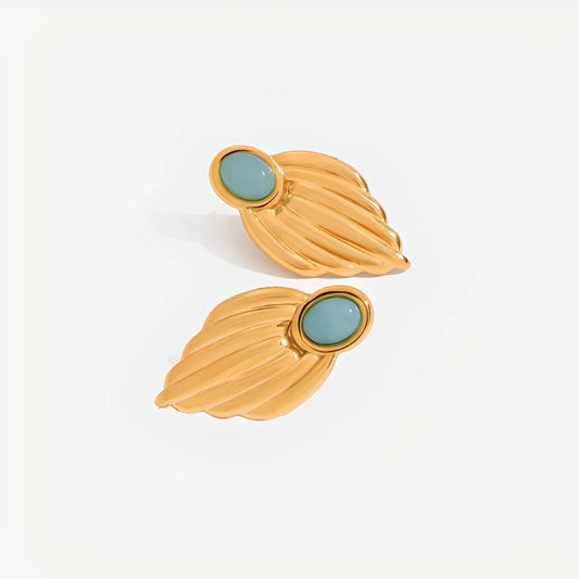 Gold leaf-shaped earrings with turquoise stones on a white background