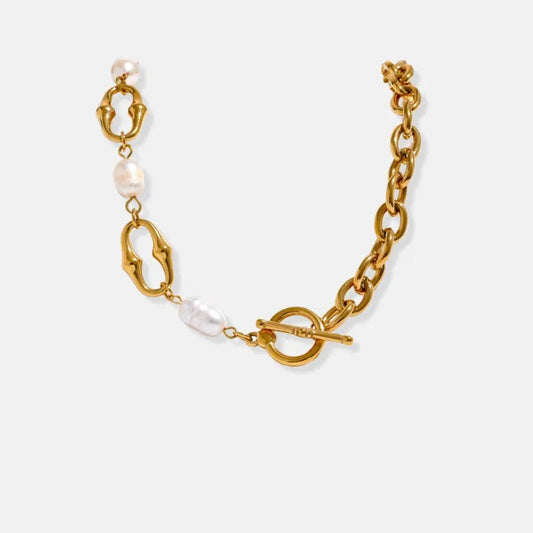 Gold bracelet with pearls on a white background