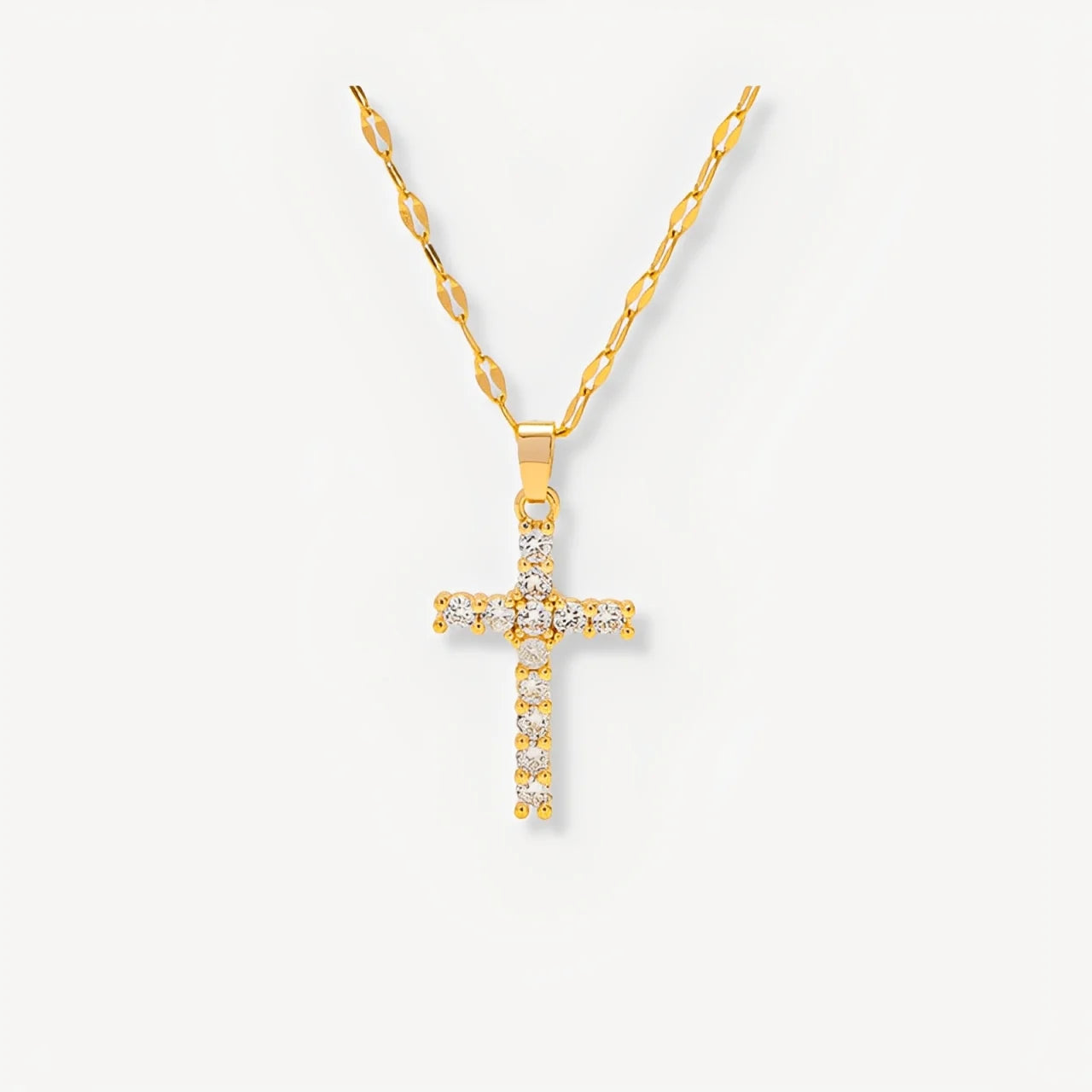 Gold cross necklace with diamonds on a white background