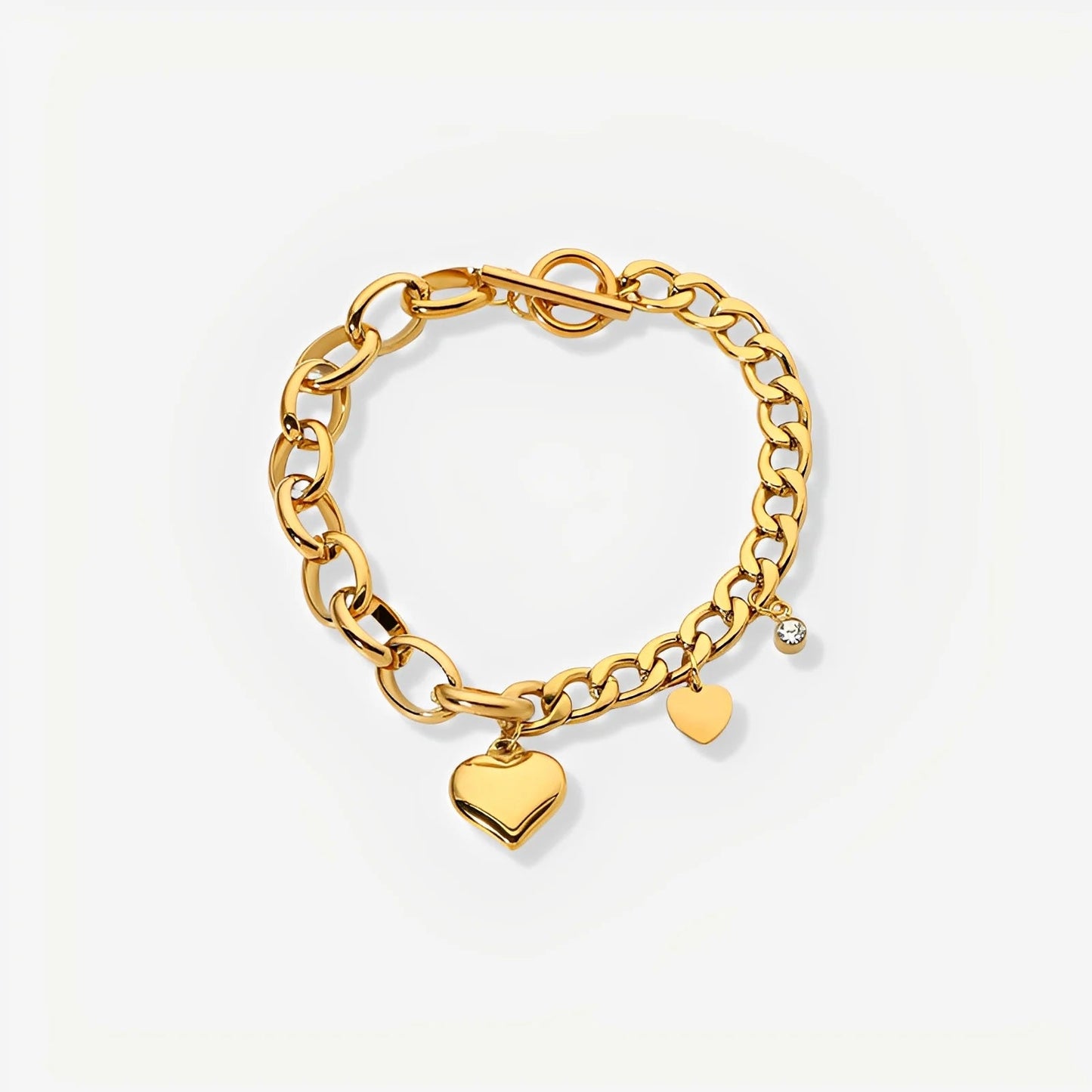 Gold chain bracelet with heart charms on a light gray background