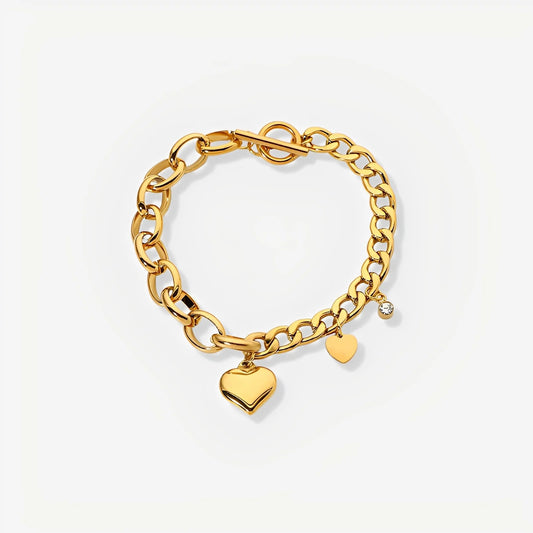 Gold chain bracelet with heart charms on a light gray background