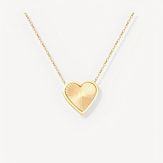 Gold heart-shaped pendant necklace on a white background