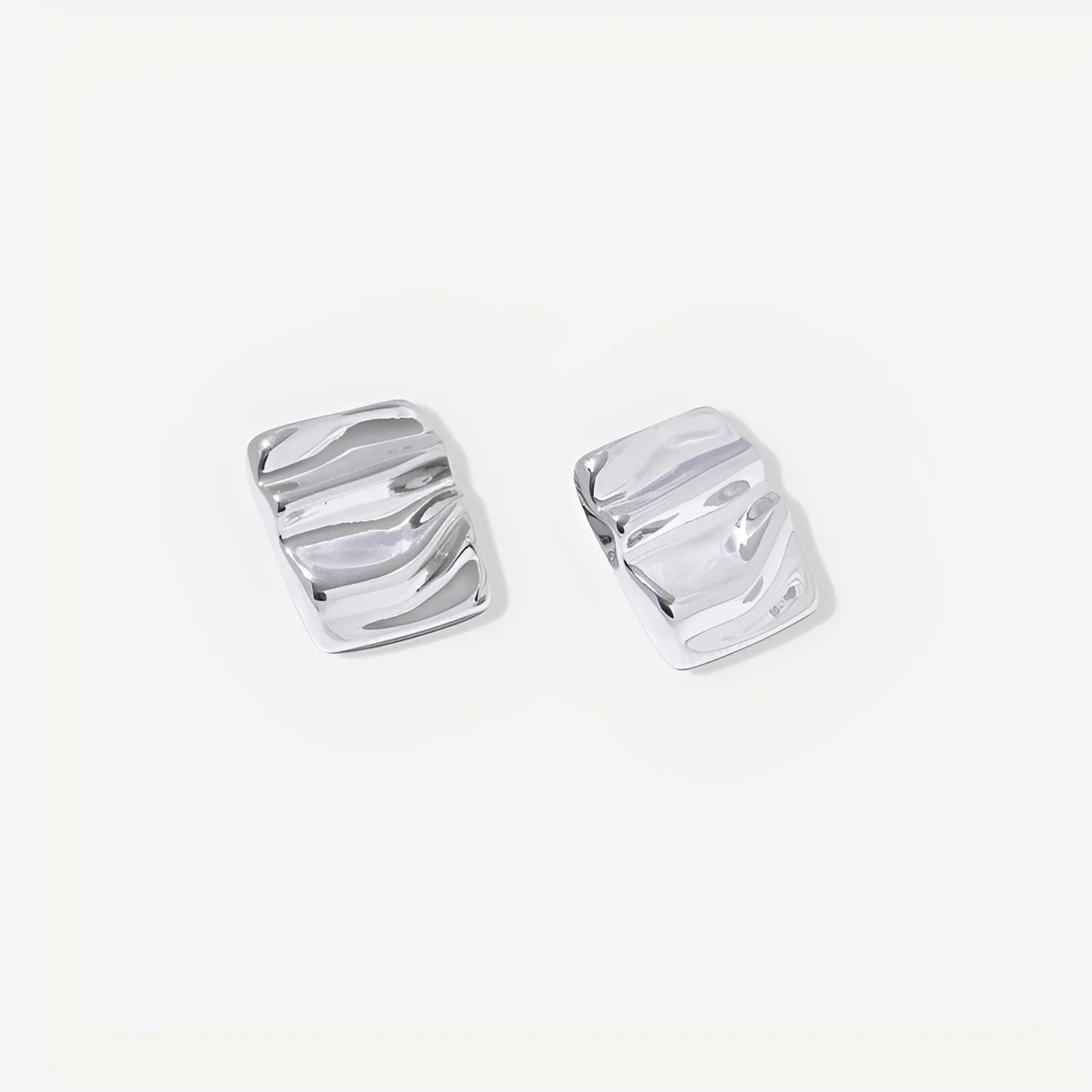 Pair of silver earrings on a white background