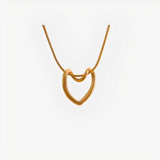 Gold necklace with a heart-shaped pendant on a white background