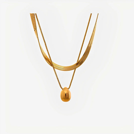 Gold necklace with a pendant on a white background