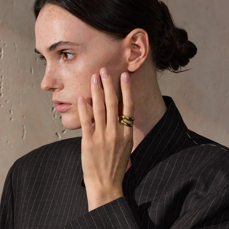 Woman wearing a black pinstripe suit with a neutral background