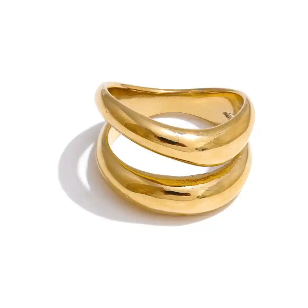 Gold ring with a twisted design on a white background
