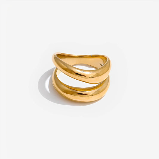 Gold ring with a wavy design on a white background
