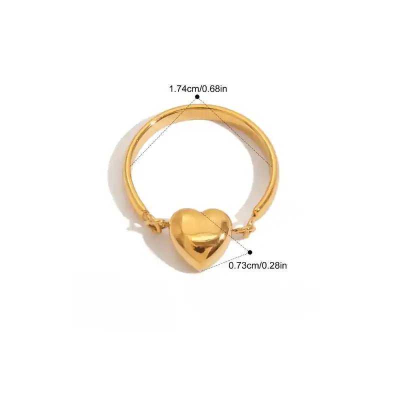 Gold heart-shaped ring with measurements on a white background