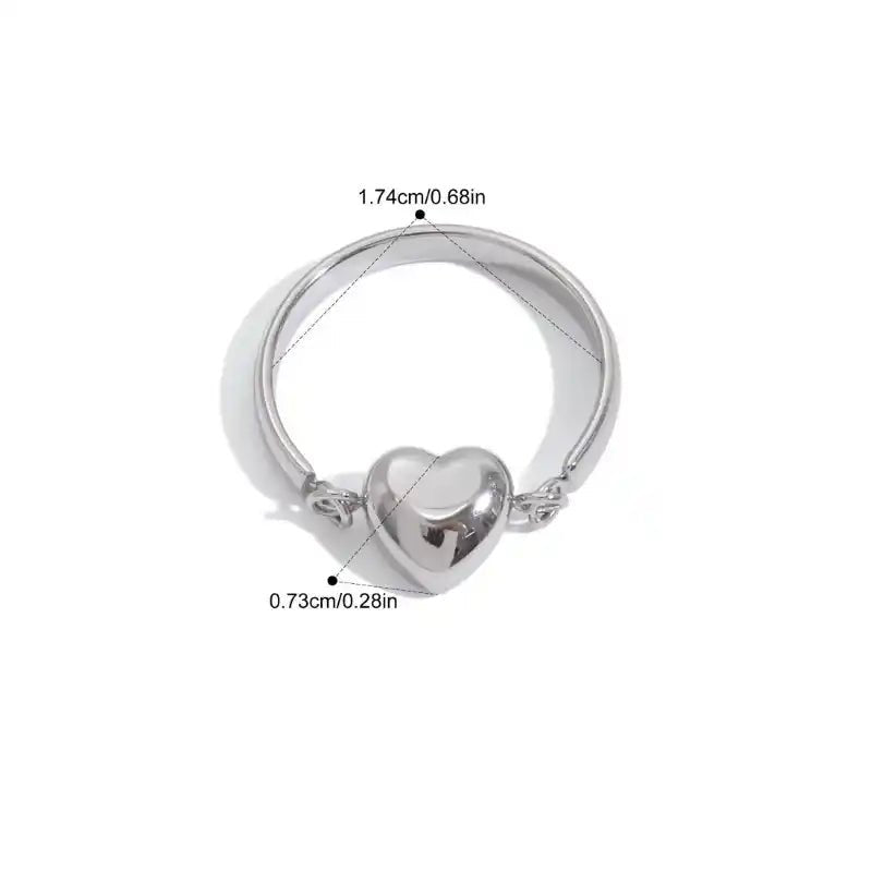 Silver ring with heart design and measurements on a white background
