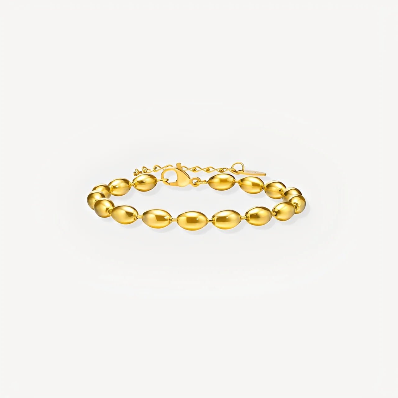 Gold bracelet on a light gray background