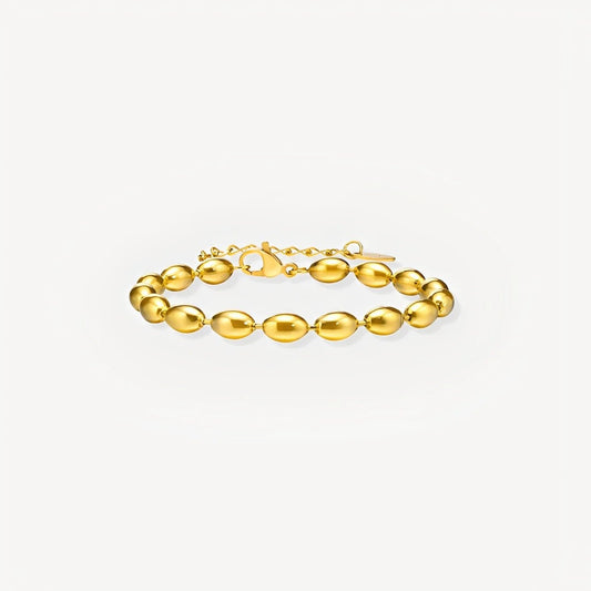 Gold bracelet on a light gray background
