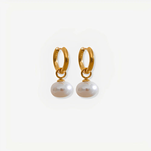 Gold hoop earrings with pearl drops on a white background