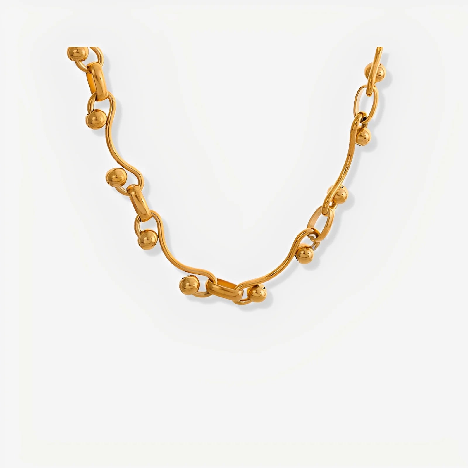 Gold bracelet on a light gray background
