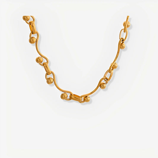 Gold bracelet on a light gray background