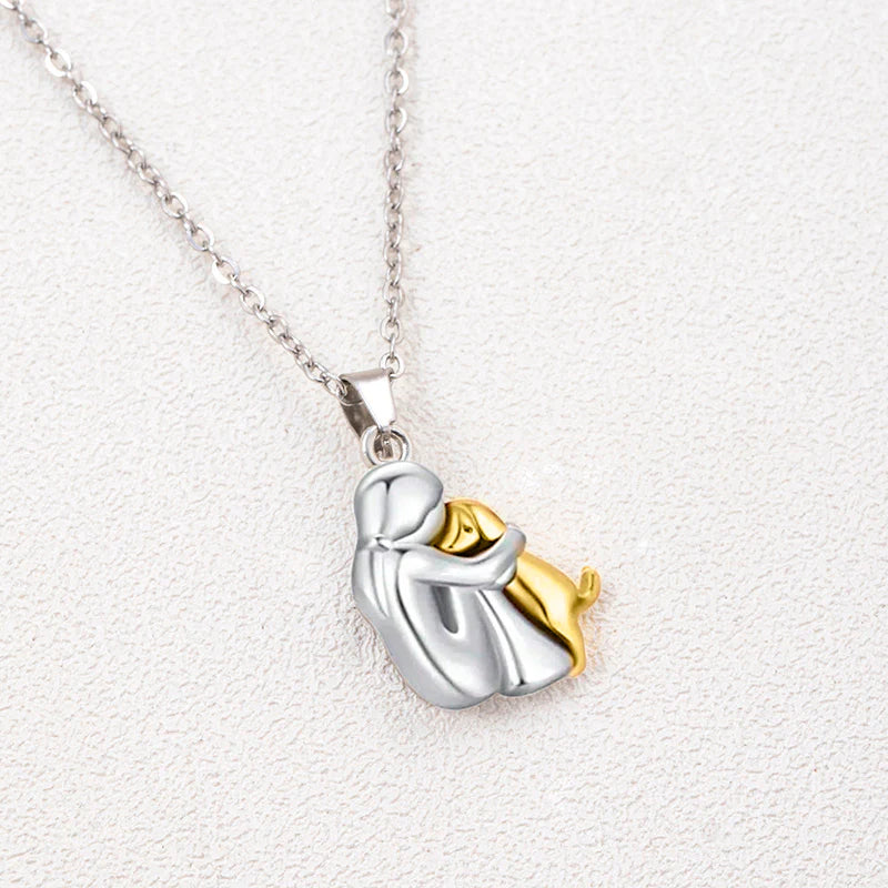 Two-toned silver and gold pendant on a white background