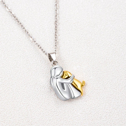 Two-toned silver and gold pendant on a white background