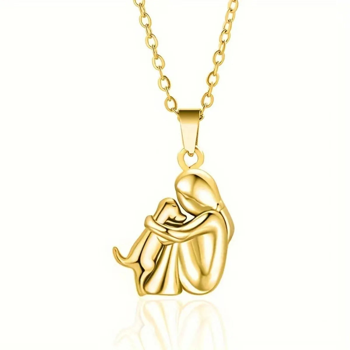 Gold necklace with a pendant of a mother and child on a white background