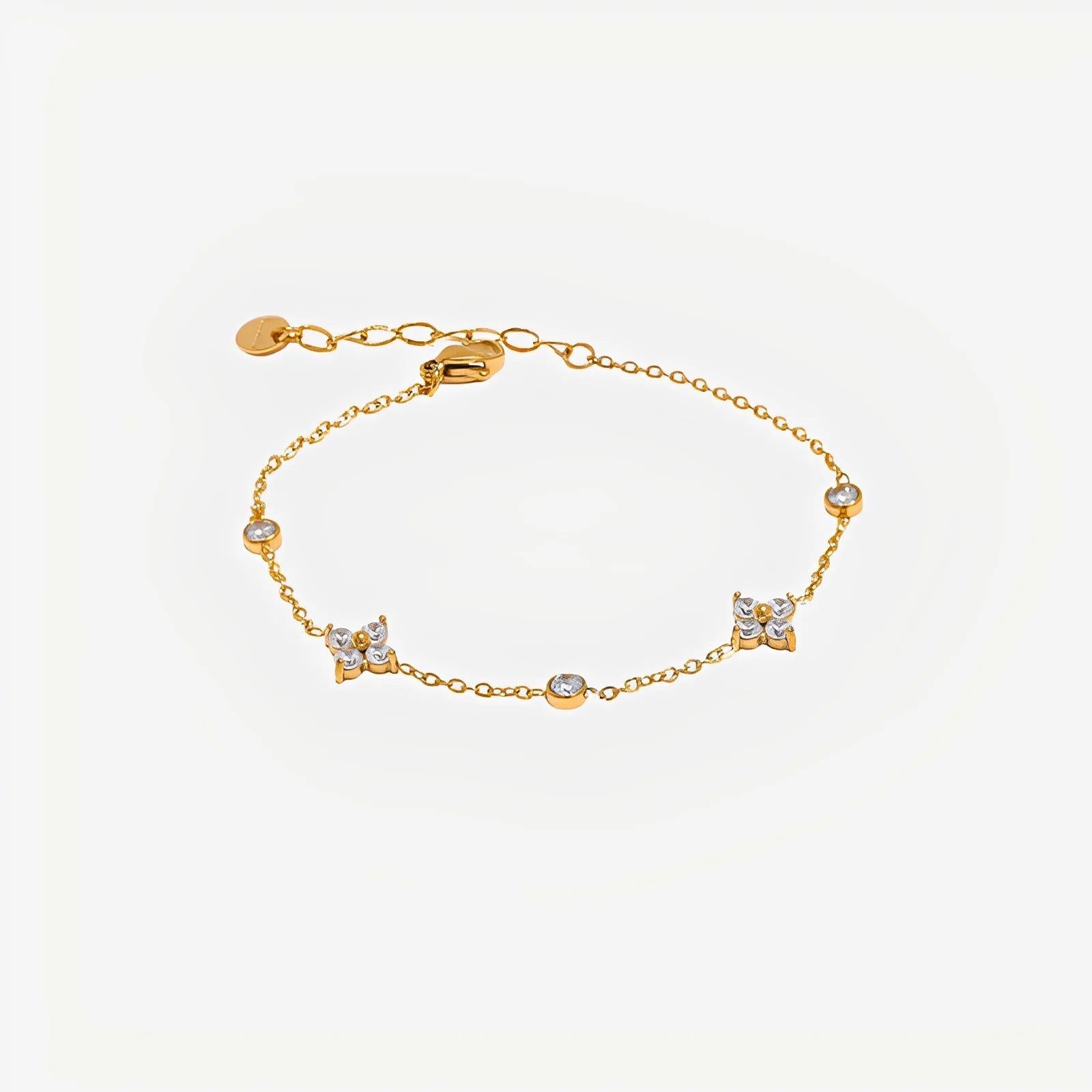 Gold bracelet with small diamonds on a light beige background